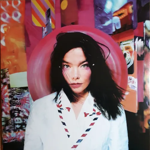 A dark-haired woman in a white airmail-striped kimono-style jacket gazes at the camera in front of a glossy pink-red circular disc, set against a colorful collage backdrop of magenta, orange and purple patterns.