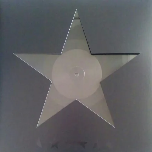 A large five-pointed star cut out of a translucent, faintly iridescent vinyl record — its circular label and center hole visible at the middle — set against a flat grey background.