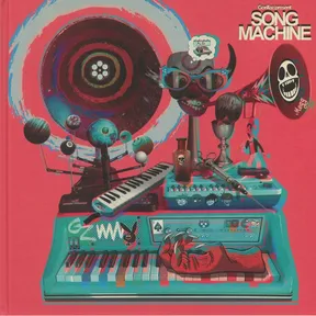 A vivid pink and teal collage of stacked music gear — keyboards, synths, a keytar, and a gramophone horn — cluttered with surreal objects like a horned masked face, floating planets, a poison bottle, a goblet, and a red hand emerging from a keyboard, set against a spiral record-like disc backdrop.