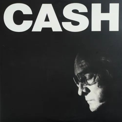 High-contrast black-and-white photo of an older man's face in profile wearing glasses, head bowed and emerging from deep shadow in the lower right, beneath large bold white capital letters across the top of a black background.
