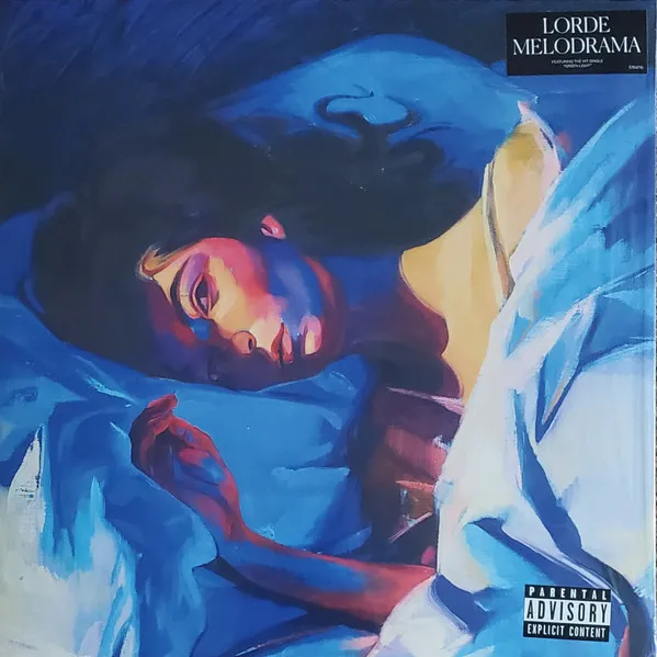 A painterly portrait of a young woman lying on her side amid rumpled bedsheets, rendered in bold blue, violet, and warm gold brushstrokes, her face lit dramatically as she gazes toward the viewer.