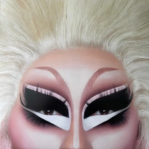 Extreme close-up of a face cropped from forehead to upper cheeks, showing dramatic drag-style eye makeup with heavy black shadow, thick lashes, pink and white graphic liner, arched brows, and voluminous platinum-blonde hair framing the pale skin.