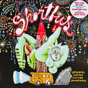 A colorful hand-painted illustration on black shows a nude green Statue of Liberty figure arching acrobatically over a pink-and-purple skyscraper, with a yellow school bus spewing gray exhaust below and bursts of multicolored fireworks filling the sky, framed by bubbly red and white script lettering.