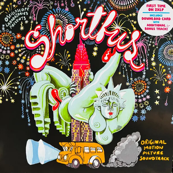 A colorful hand-painted illustration on black shows a nude green Statue of Liberty figure arching acrobatically over a pink-and-purple skyscraper, with a yellow school bus spewing gray exhaust below and bursts of multicolored fireworks filling the sky, framed by bubbly red and white script lettering.